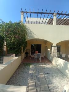 a patio of a house with a table and chairs at 2 Bedroom Maisonette Mandria Paphos Cyprus in Paphos