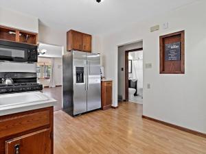 an empty kitchen with a stainless steel refrigerator at Convenient 5 bedroomMetro Milwaukee Brewers! in West Allis