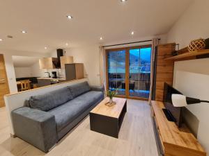 a living room with a couch and a table at Ferienwohnung Resch in Ramsau