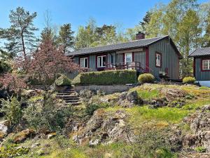 a house on top of a hill with a yard at Holiday home NYNÄSHAMN in Nynäshamn