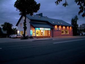 a building with lights on the side of a street at Eiva in Marijampolė