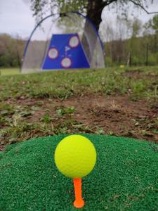 a green ball on a golf course with a tent at romagnoli family cottage in Ameno