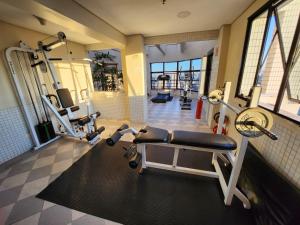 a gym with several treadmills and machines in a room at Residence Flat 143 em Santana in São Paulo