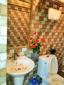 a bathroom with a sink and a toilet at Tam Coc Eco House in Ninh Binh