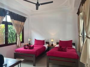 Un ou plusieurs lits dans un hébergement de l'établissement Amara Beach Resort Koh Phangan