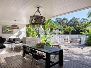 a living room with a black table and chairs at Atlantic Byron Bay in Byron Bay