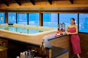a woman standing in front of a bath tub in a boat at Maliekal Heritance Cherai Beach Cochin in Cherai Beach