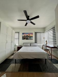 a bedroom with a bed and a ceiling fan at Home in Aspire Prime Residences - Block 1 Lot 39 in San Fernando