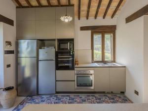 a kitchen with stainless steel appliances and a window at Belvilla by OYO Villa Anna in SantʼIppolito