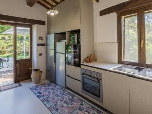 a kitchen with a stainless steel refrigerator and a window at Belvilla by OYO Villa Anna in SantʼIppolito