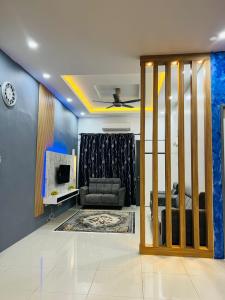 a living room with a couch and a tv at SRS WIN Homestay in Sungai Petani