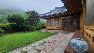 a house with a vase sitting outside of it at Ever Healing House in Namugil