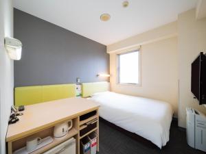 Voodi või voodid majutusasutuse Super Hotel Tokyo Kameido toas
