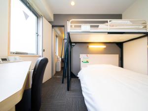 Voodi või voodid majutusasutuse Super Hotel Tokyo Kameido toas