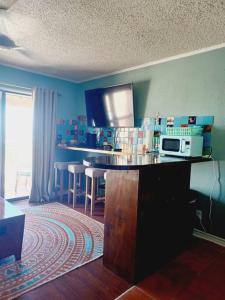 a kitchen with a counter top with a microwave at Cozy one bedroom condo in Corpus Christi