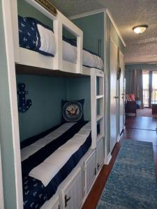 a room with three bunk beds in a house at Cozy one bedroom condo in Corpus Christi
