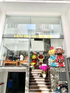 a store front with a staircase and flowers at Luu Gia Hotel in Nha Trang