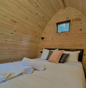 1 dormitorio con 1 cama en una pared de madera en Beechworth Holiday Park, en Beechworth