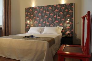a hotel room with a bed and a lamp at Lucca in Villa Lucrezia in Lucca