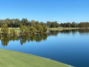 a view of a lake with trees in the background at Luxury house in heart of Hopeisland in Gold Coast