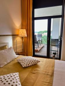 a bedroom with a bed with a view of a balcony at Lux -Luxury Sea and Mountains View Apartment-NEW in Koper