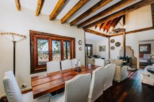 a dining room with a wooden table and white chairs at Apple Tree Cottage - An Idyllic Country Reset in Mudgee