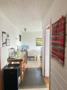 a kitchen with a counter and a sink in a room at Cabañas Lovel-Van in Curanipe