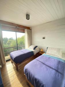 A bed or beds in a room at Cabañas Lovel-Van