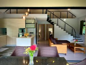 a kitchen and living room with a vase on a table at Fare Luna - Comfy New home in Bora Bora in Bora Bora