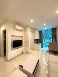 a large living room with a tv and a couch at SANG Hotel Apartment Sai Gon in Ho Chi Minh City