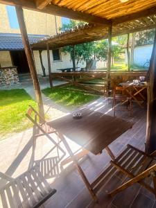 a patio with two chairs and a table and a woodenilion at Bukska Sadyba in Buki