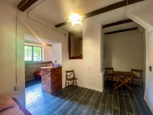 a room with a fireplace and a table and chairs at Bukska Sadyba in Buki