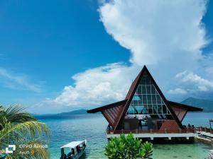 a building in the water next to the ocean at 4 Sisters Divers in Bunaken