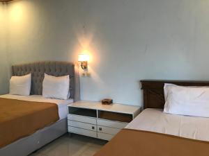 Postel nebo postele na pokoji v ubytování Bello Ethnic Bungalow & Resto