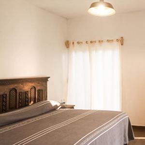 a bedroom with a bed and a large window at Hospedaje Casa Teotleco in Tepoztlán +17 photos