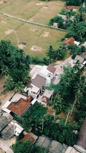 an aerial view of a house in a field with palm trees at Kmanda House in Pangandaran +19 photos