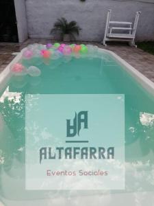 a swimming pool with a sign that reads eleftherarma events societies at casa con piscina, alojamiento hasta 12 personas in Asuncion