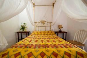 1 dormitorio con 1 cama grande y edredón amarillo en Hacienda la Luna, 
