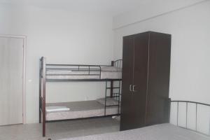 a room with two bunk beds and a locker at Paralia Apartments in Paralia Katerinis