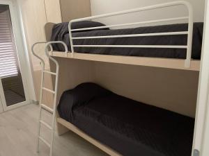 a couple of bunk beds in a room at Residence Verde Mare in Massignano