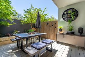 a patio with a table and chairs and a fence at Dunn Bay Apartment 4 - Dunsborough in Dunsborough