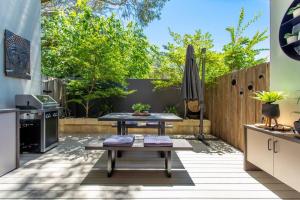 une terrasse avec une table et un parasol dans l'établissement Dunn Bay Apartment 4 - Dunsborough, à Dunsborough