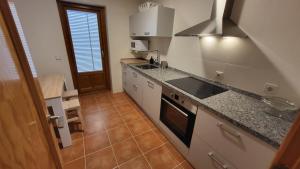 a kitchen with a sink and a stove at Las Casitas de Bernuy VUT in Segovia