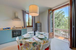 eine Küche und ein Esszimmer mit einem Tisch und einem Balkon in der Unterkunft Casa Lia - Happy Rentals in Desenzano del Garda