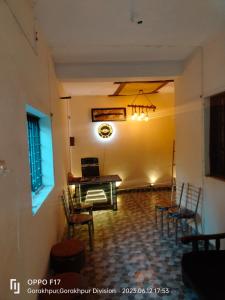 a dining room with a table and chairs at Privyrooms in Gorakhpur