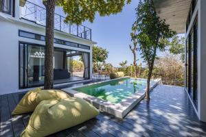 an external view of a house with a swimming pool at Pahili Pool Villas Koh Tao - SHA Plus in Koh Tao