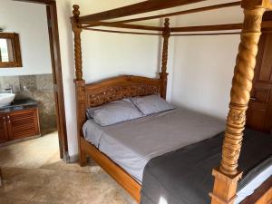 a bedroom with a canopy bed and a sink at Ocean views, peaceful living in Airsatang +53 photos