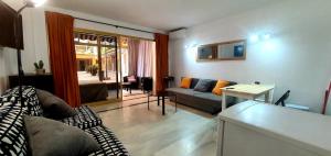 a living room with a couch and a table at Primera línea de playa in Marbella