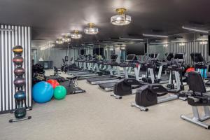 a gym with several treadmills and cardio machines at The Madison Hotel in Morristown