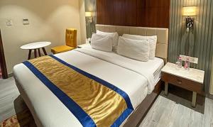 a hotel room with a bed and a table at FabHotel Prime The Wish in Jaipur